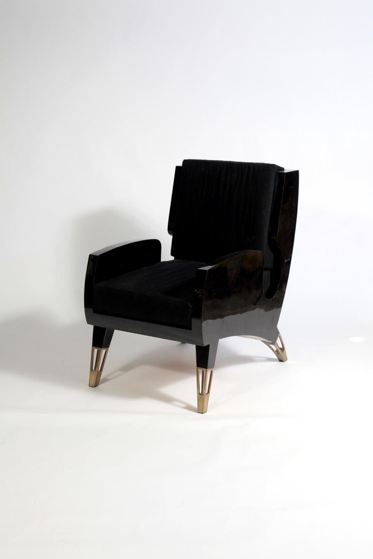 The Saint Germain is a sophisticated armchair in a stylish midcentury shape designed for a contemporary home. Perfect for a conversation. This piece is inlaid in black pen shell creating a sleek and luxurious finish. The ends of the feet are inlaid