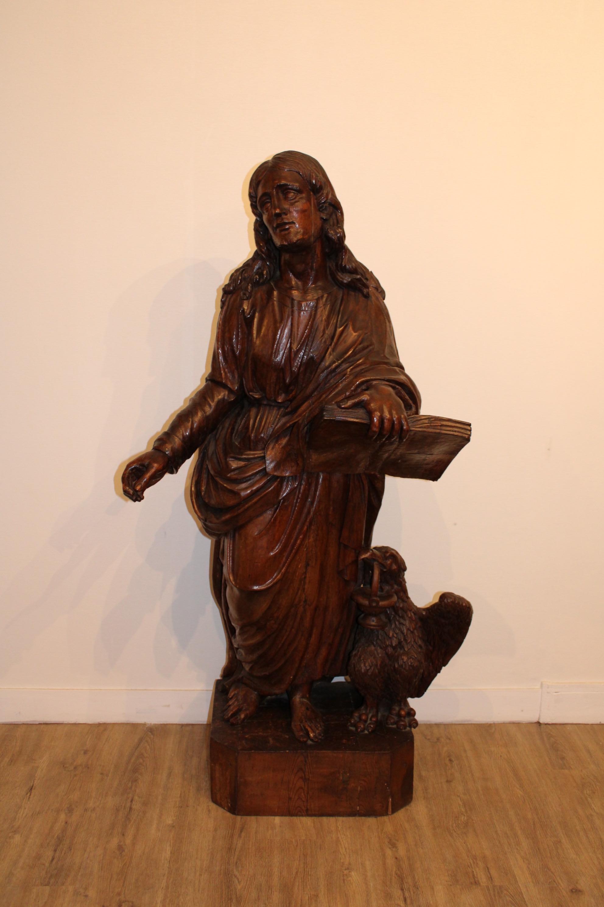 Big sculpture in wood 
Representing Saint Jean with an eagle
End of 17th century 

Measures: Height :145 cm 
Base : 48 x 36 cm.