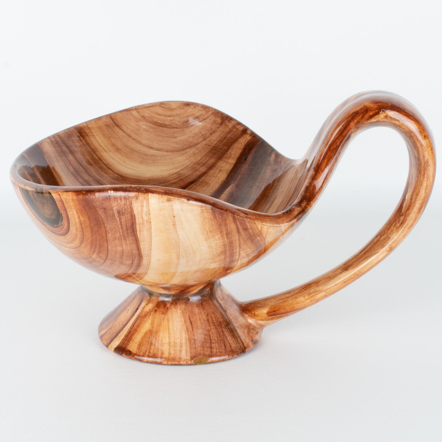 This superb Mid-Century modernist ceramic bowl or vase was crafted in Marseille, France, circa 1950, by the earthenware factory Saint-Jean-du-Désert (SJD). The rare bowl with a single handle boasts a unique motif that resembles wood, finished with a