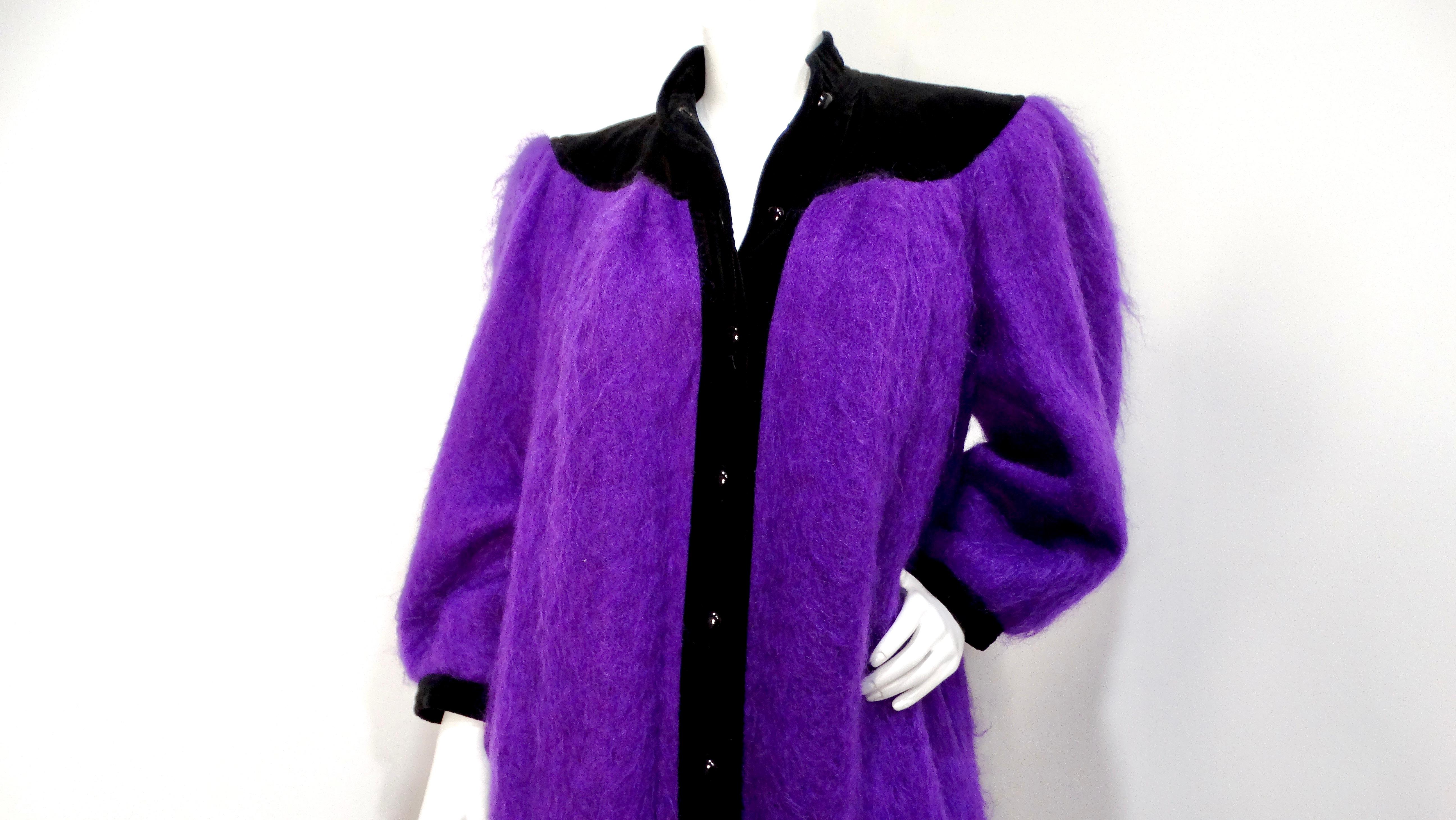 Step into the spotlight with the Saint Laurent 1980s Glamour Purple Puff Sleeve Coat, an iconic piece that captures the essence of vintage luxury. This standout coat is crafted from a wool-like fabric in a rich, vibrant purple, exuding both elegance