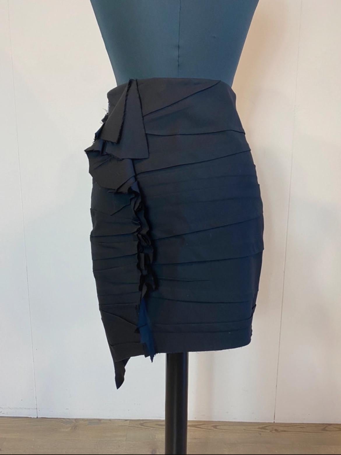 Saint Laurent 2017 asymmetrical skirt in black wool with side zipper.
It features a rhinestone front detail and the same detail in the back without rhinestones.
Item is in very good condition 
Short part length 49 cm
Long part length 64 cm
Waist cm