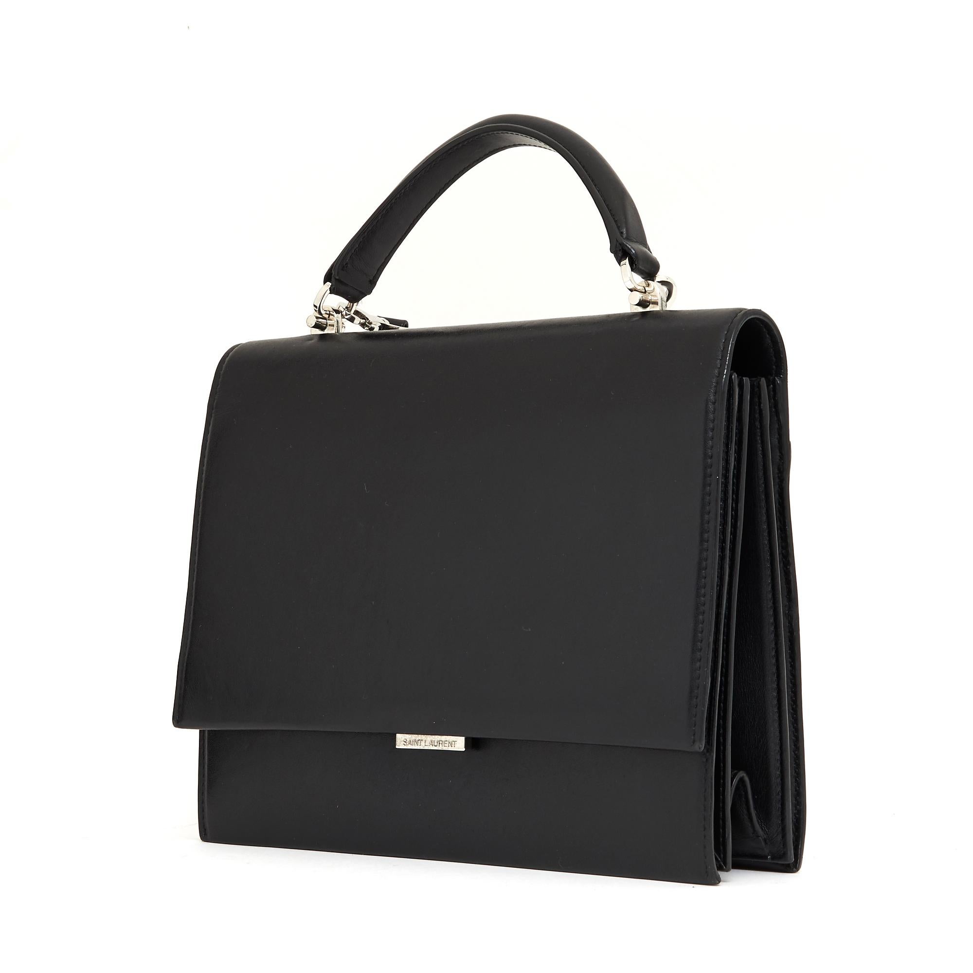 Saint Laurent Babylone model bag in black leather, black canvas interior with 3 compartments including 1 with a zipped pocket, vanity mirror with its stitched leather tab, 1 last pocket on the back, 1 handle for carrying the hand and 1 removable and