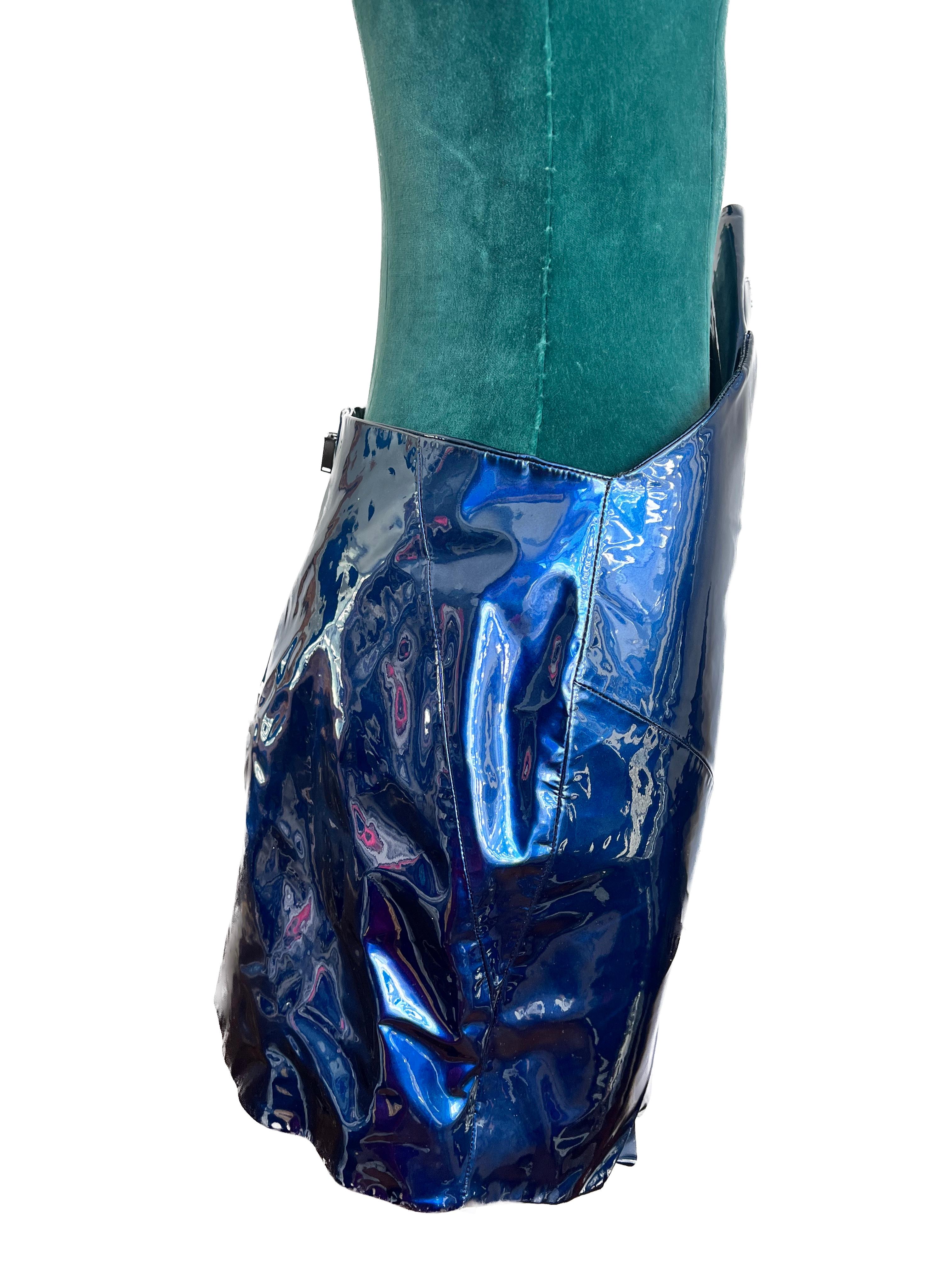 It seems you're describing a specific fashion item, a 2017 blue patent mini leather skirt with ruffle detail, brand new with tags, and in size F40. Here's how you might highlight the features of this stylish piece:

Material and Finish:
Crafted from