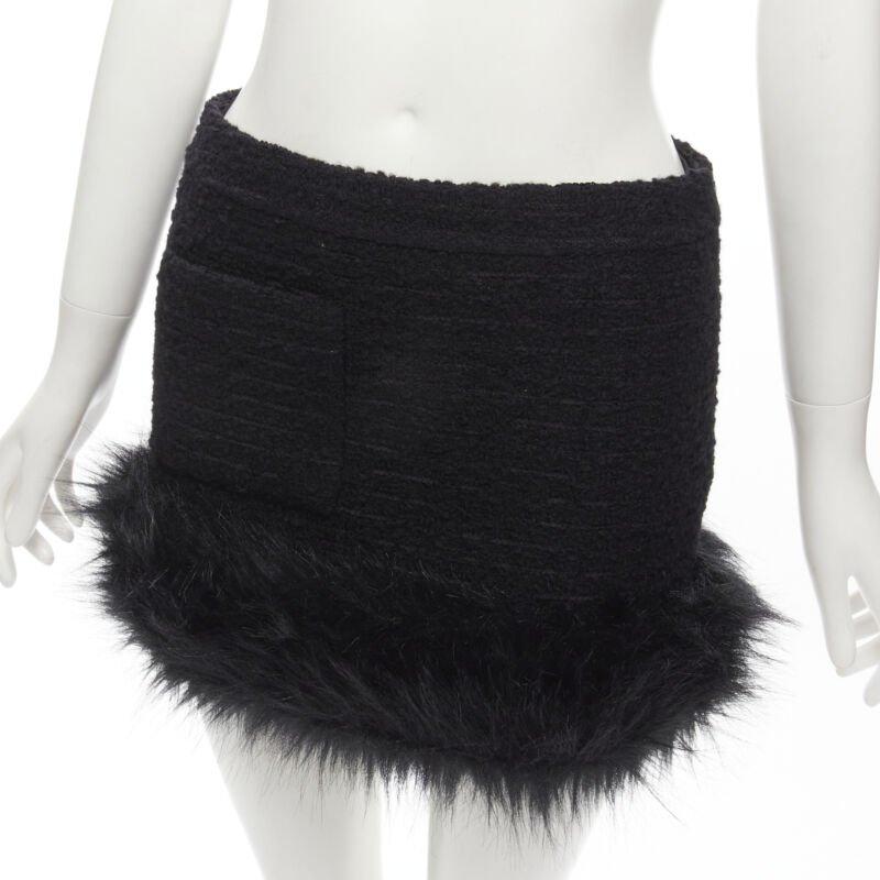 SAINT LAURENT 2022 black tweed faux fur trimmed mini skirt FR34 XS
Reference: AAWC/A00012
Brand: Saint Laurent
Designer: Anthony Vaccarello
Collection: 2021
Material: Tweed
Color: Black
Pattern: Solid
Closure: Zip
Lining:  Fully Lined
Extra Details: