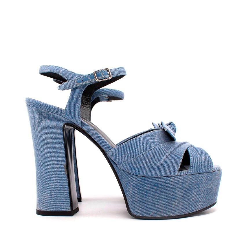 Saint Laurent Acid Wash Blue Denim Candy Platform Heeled Sandals
 

 - Light blue cotton and leather 'Candy 80' bow sandals
 - Featuring a peep toe and crossover straps to the front
 - An ankle strap with a side buckle fastening
 - Set on a platform