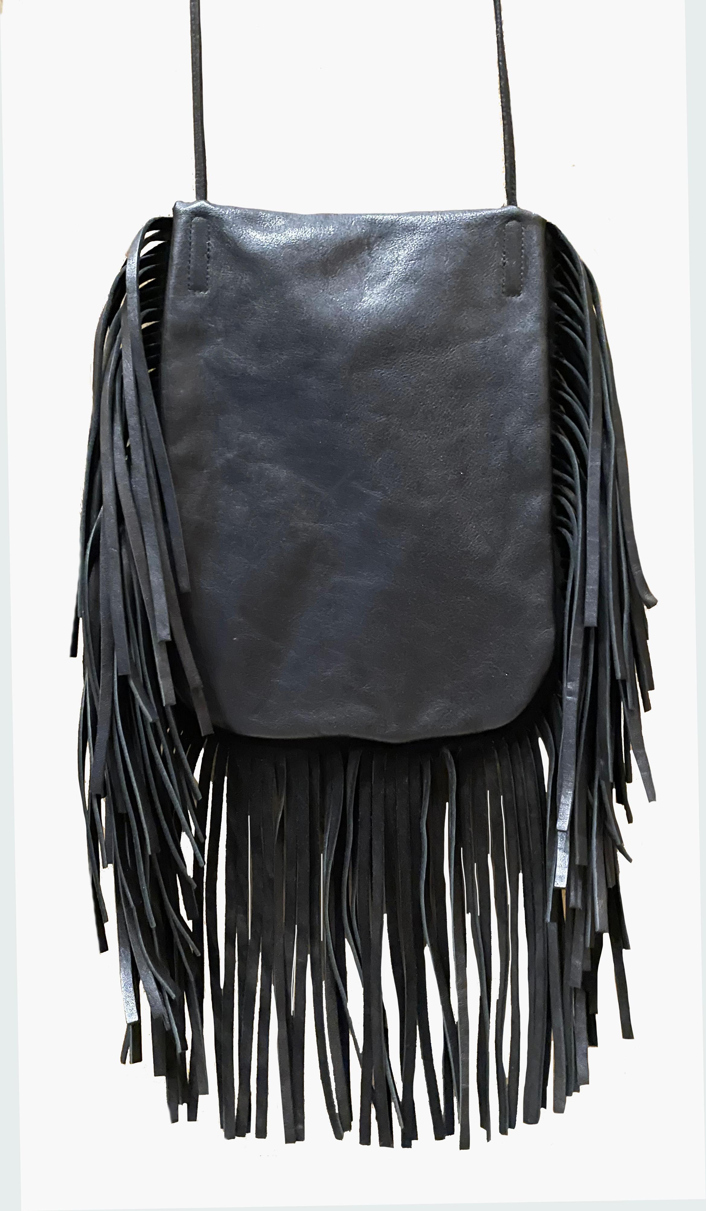 
Leather cross-body bag by Saint Laurent with a silver-tone hardware and YSL logo. In a bohemian style. Decorated with fringe. Long strap. Opens with a flap and tassels with chain and YSL logo. Lined in black suede. 
Period: 2000s
Length: