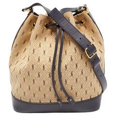 Saint Laurent Bucket Bag aus Segeltuch und Leder mit Monogramm und Kordelzug in Beige/Schwarz