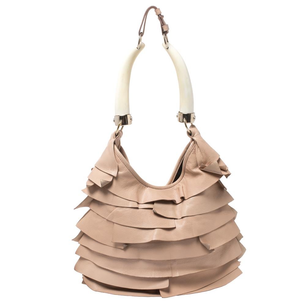 The St.Tropez Mombasa hobo combines charming feminine ruffles with a chic twist. The exterior is crafted from beautifully layered beige leather that is complimented by polished leather and horn handles. The spacious interior is lined with soft dark