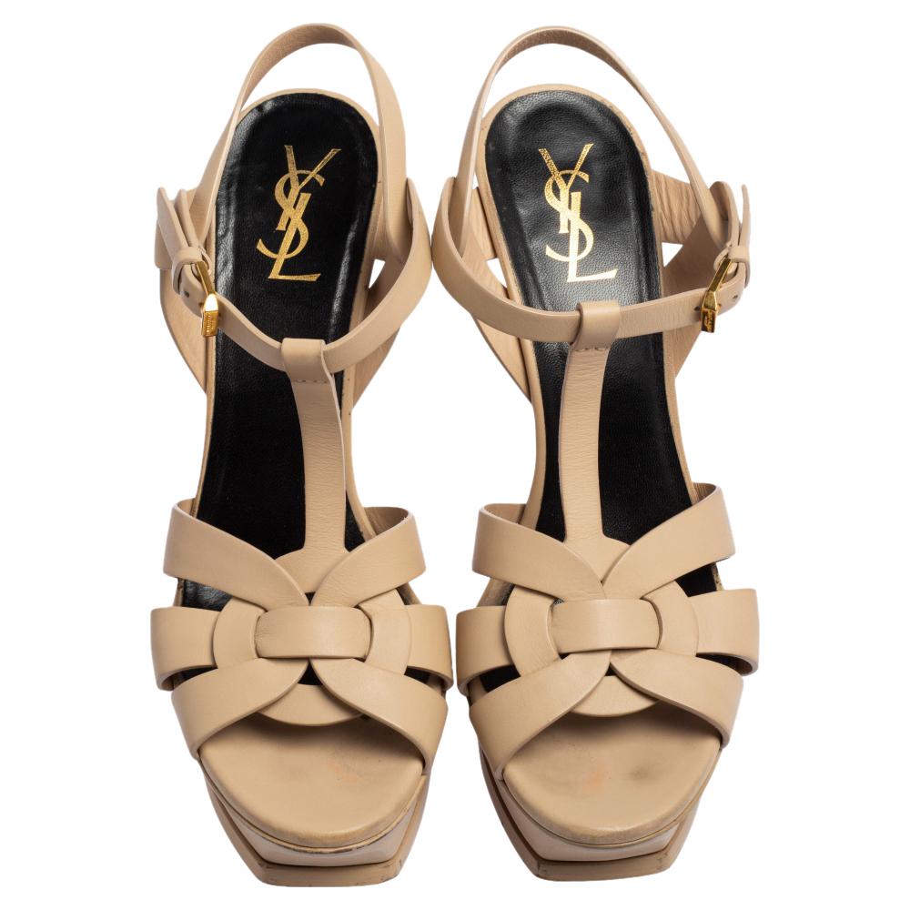 One of the most sought-after designs from Saint Laurent is their Tribute sandals. They are such a craze amongst fashionistas around the world, and it is time you own one yourself. These beige ones are designed with leather straps, ankle fastenings,