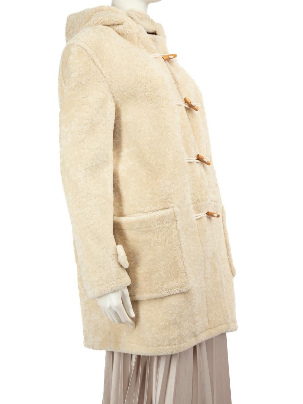CONDITION is Very good. Minimal wear to coat is evident. Minor discolouration marks on the left sleeve on the front and back on this used Saint Laurent designer resale item.
 
 Details
 Beige
 Shearling
 Coat
 Mid length
 Long sleeves
 Buttoned