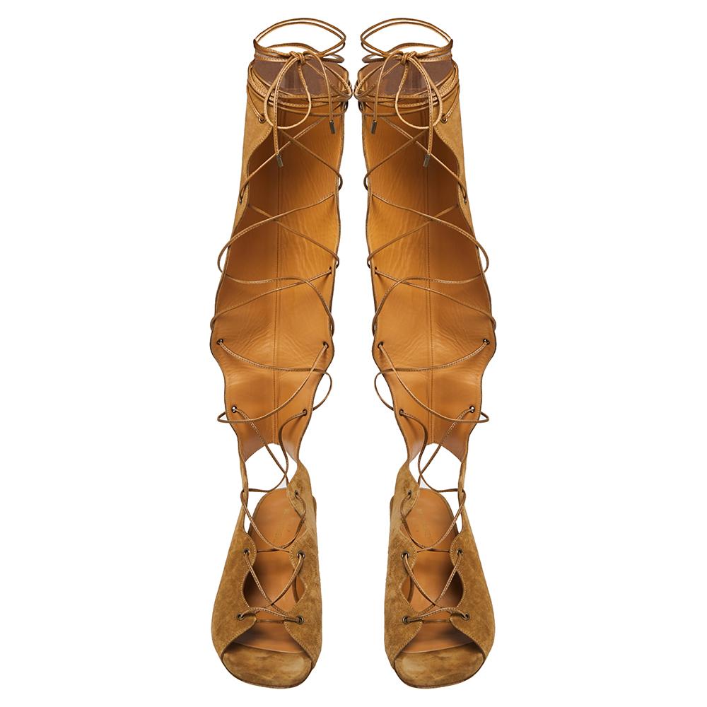 Aquazzura presents to you these beige-hued sandals that will frame your feet beautifully. They are crafted from suede in a gladiator design and complemented with tie-up fastenings and short block heels.

