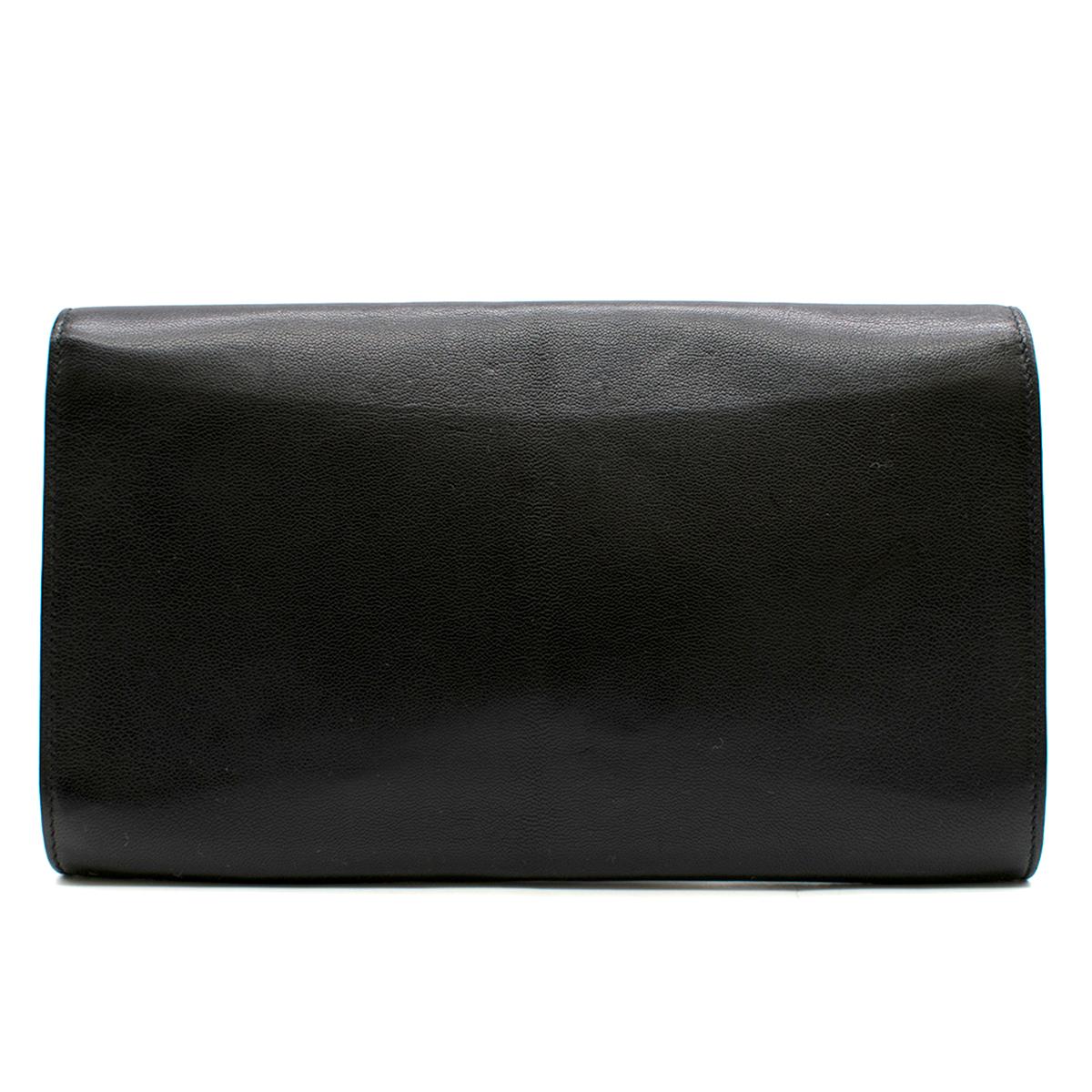 Saint Laurent Belle De Jour Black Leather Clutch Bag 

- Black Clutch Bag 
- Leather body, strapless
- Flap front with magnetic fastening closure 
- Featured stitched logo at front 
- Black satin lining with internal side slip pocket

This item has