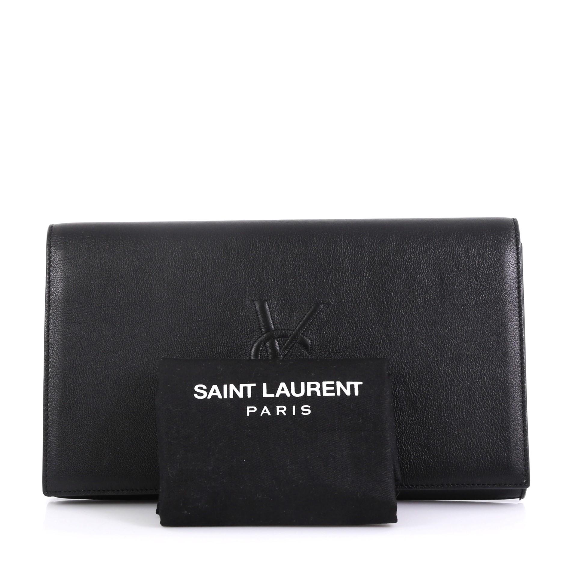 This Saint Laurent Belle de Jour Clutch Leather Large, crafted in black leather, features gold-tone hardware. Its magnetic snap closure opens to a black satin interior with slip pocket. 

Estimated Retail Price: $895
Condition: Great. Slight