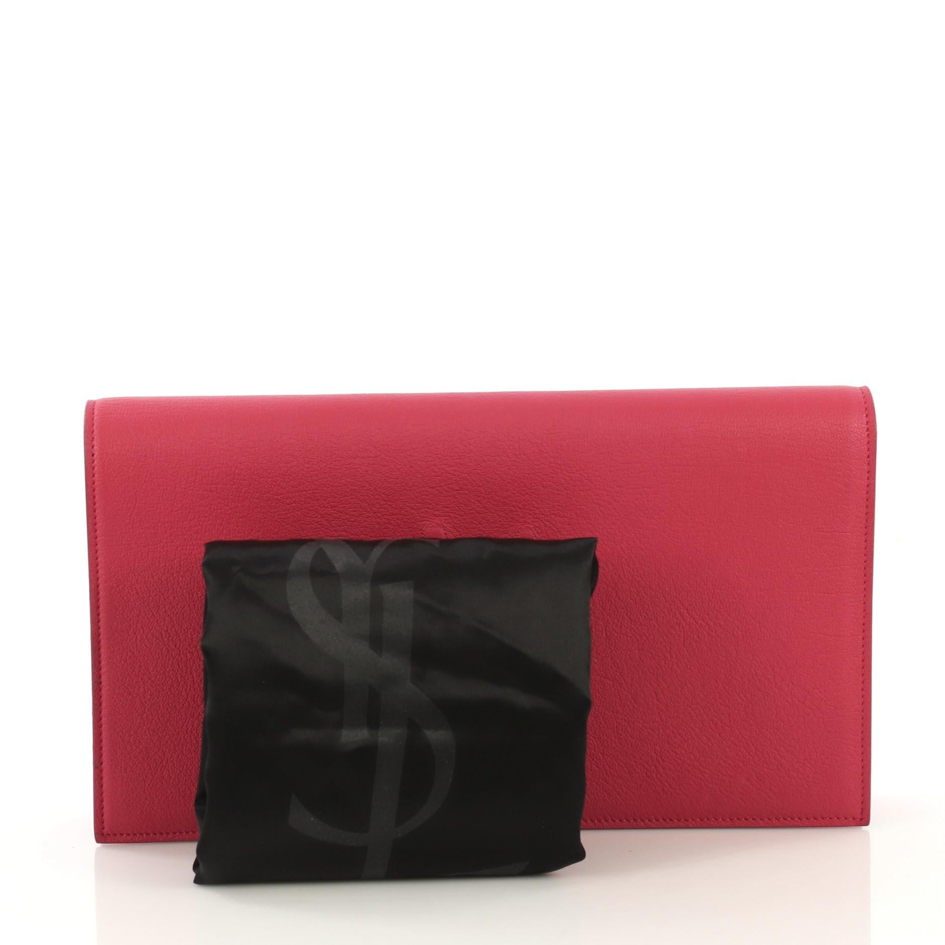 This Saint Laurent Belle de Jour Clutch Leather Large, crafted in pink leather, features gold-tone hardware. Its magnetic snap closure opens to a black satin interior with slip pocket. 

Estimated Retail Price: $895
Condition: Excellent. Slight