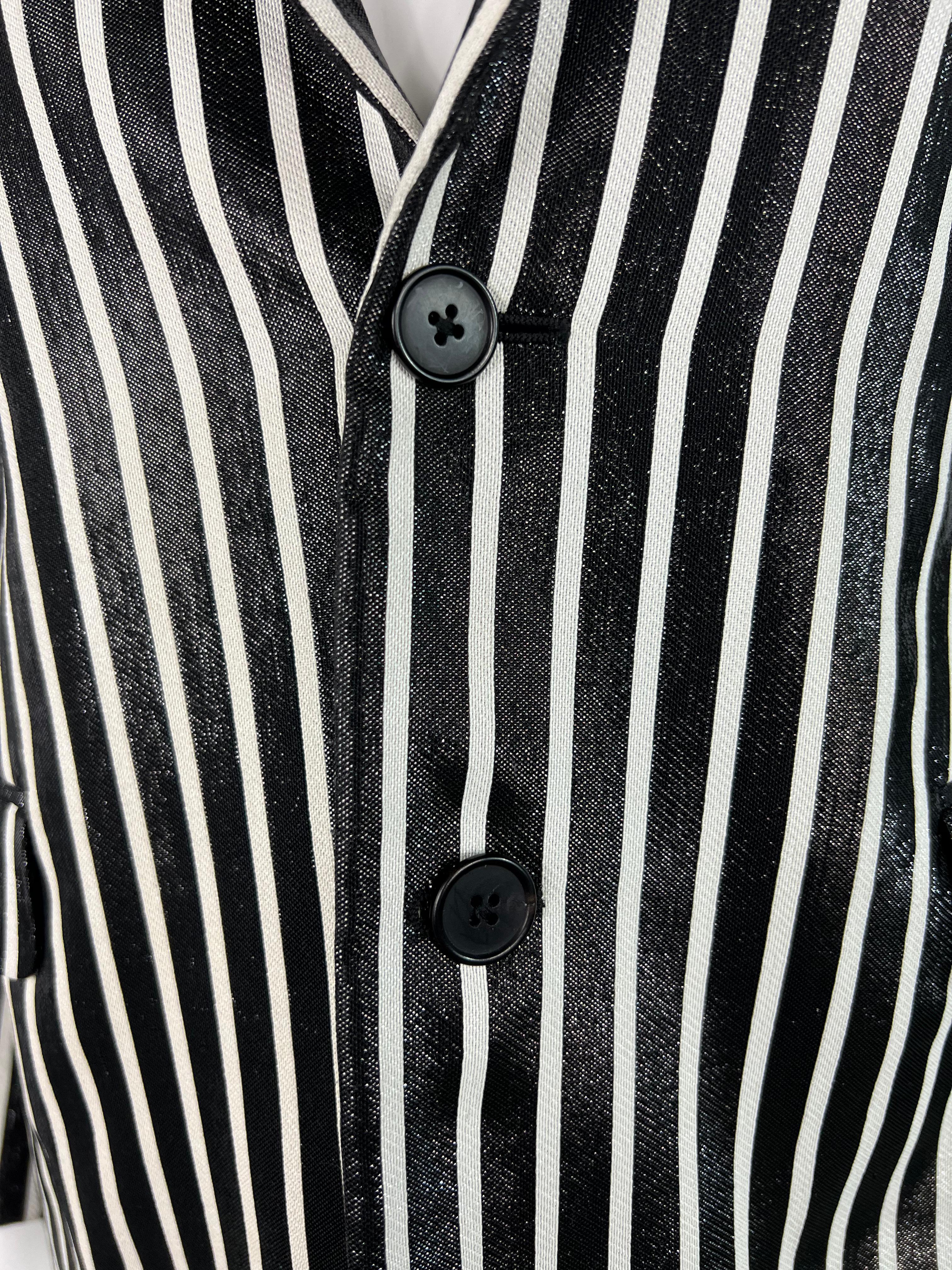Product details:

The blazer features black and white striped pattern with front button closure and pocket on each side.