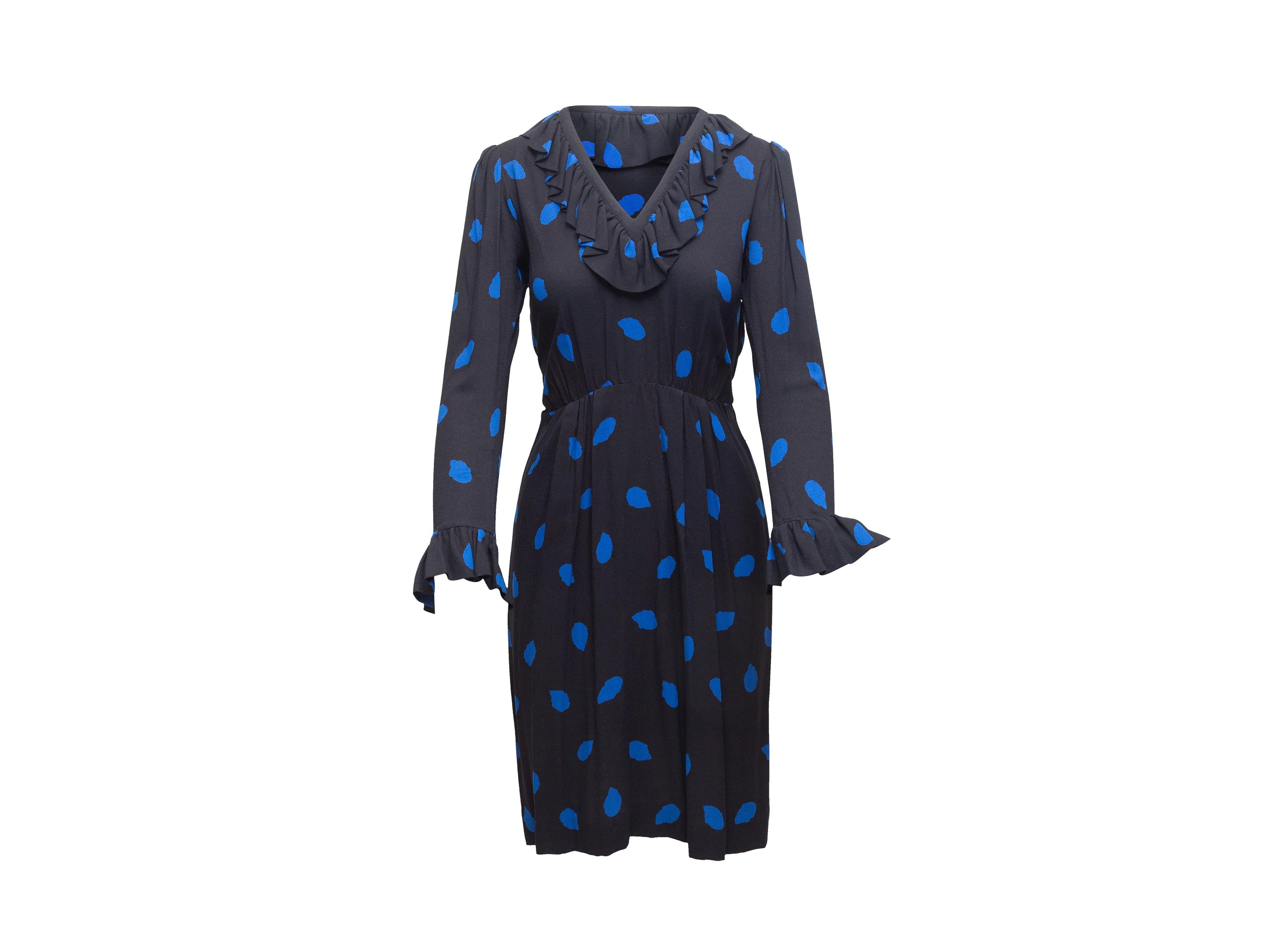 Product details: Vintage black and blue polka dot print dress by Saint Laurent. Ruffle trim throughout. V-neck. Long sleeves. 32