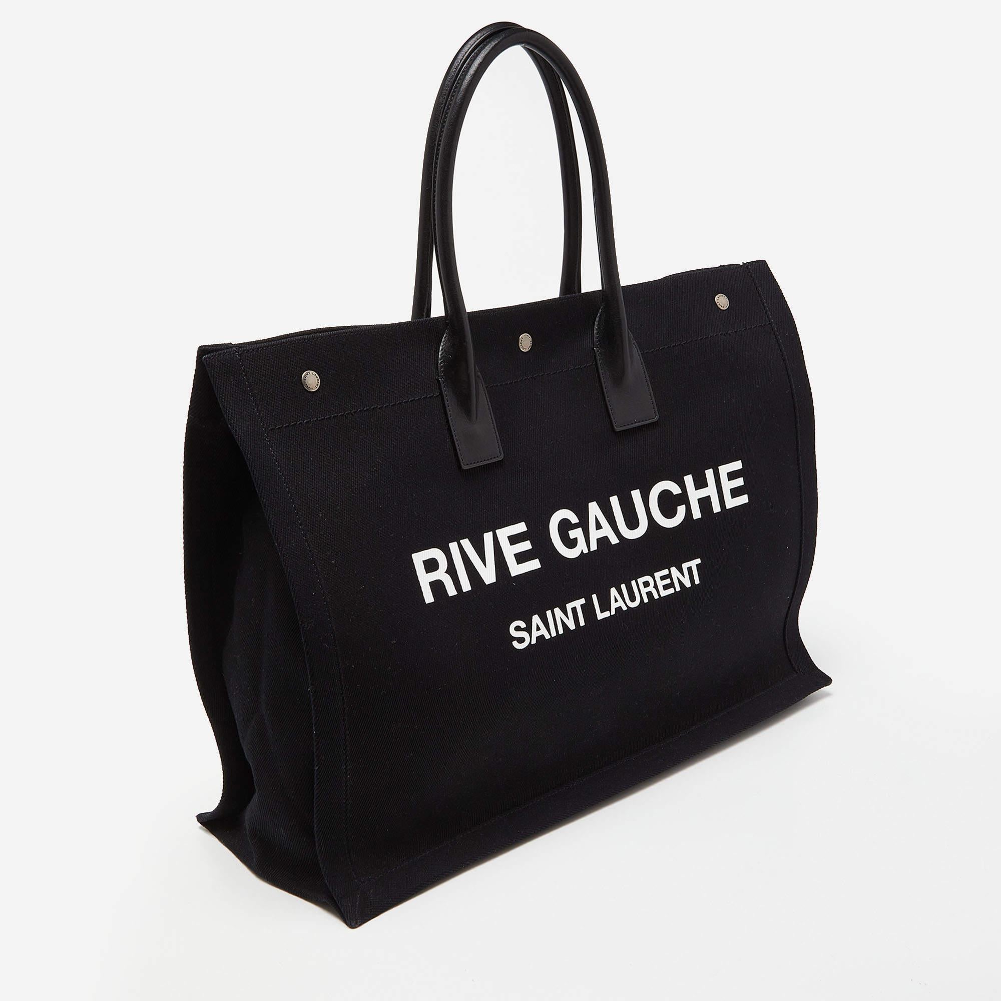 This Saint Laurent tote promises to take you through the day with ease, whether you're at work or out and about in the city. From its design to its structure, the canvas & leather bag promises charm and durability. It has top handles, 