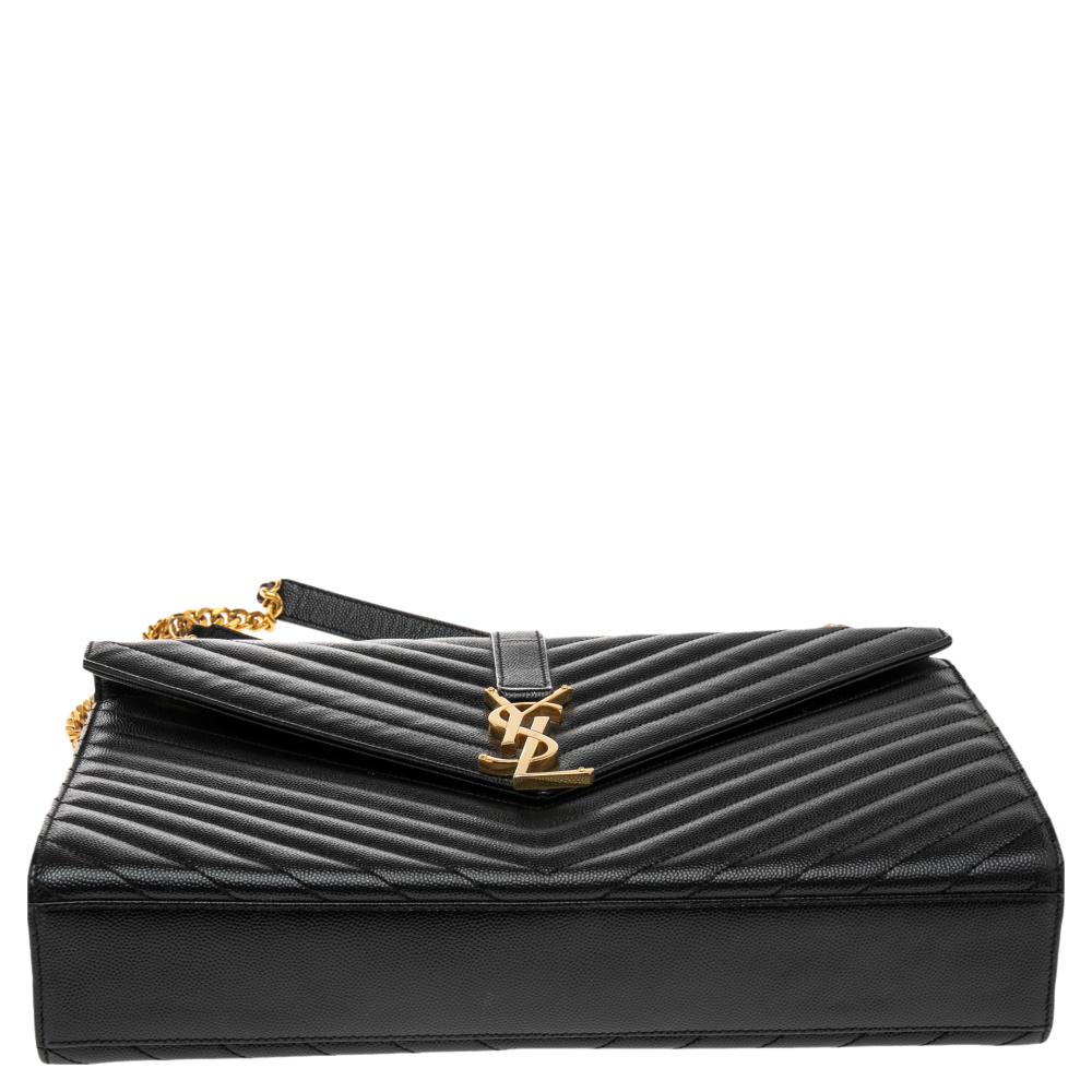 Fashioned using chevron-quilted leather into a structured silhouette, this Saint Laurent Monogram Envelope shoulder bag has high style and a timeless charm. It has a flap design and the front is highlighted with a gold-tone YSL logo. The interior is