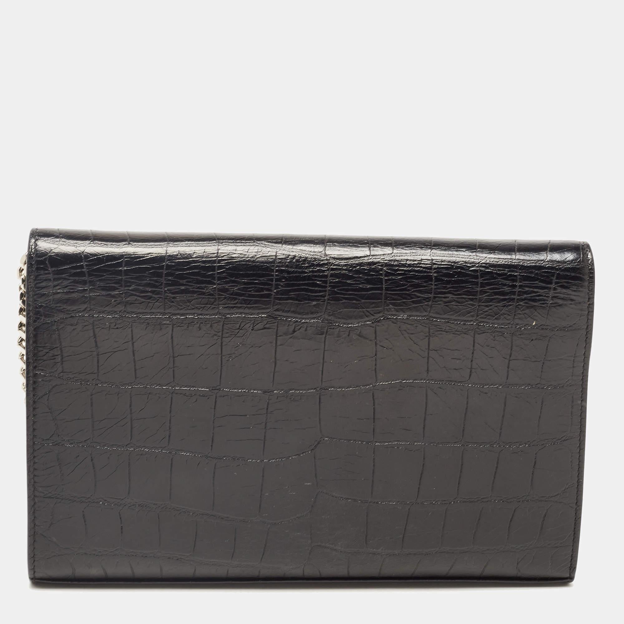Meticulously crafted from blue croc-embossed leather, this Saint Laurent Kate clutch exudes just the right amount of sophistication! The bag features the YSL logo on the front flap and a fabric and leather-lined compartment to store your essentials.