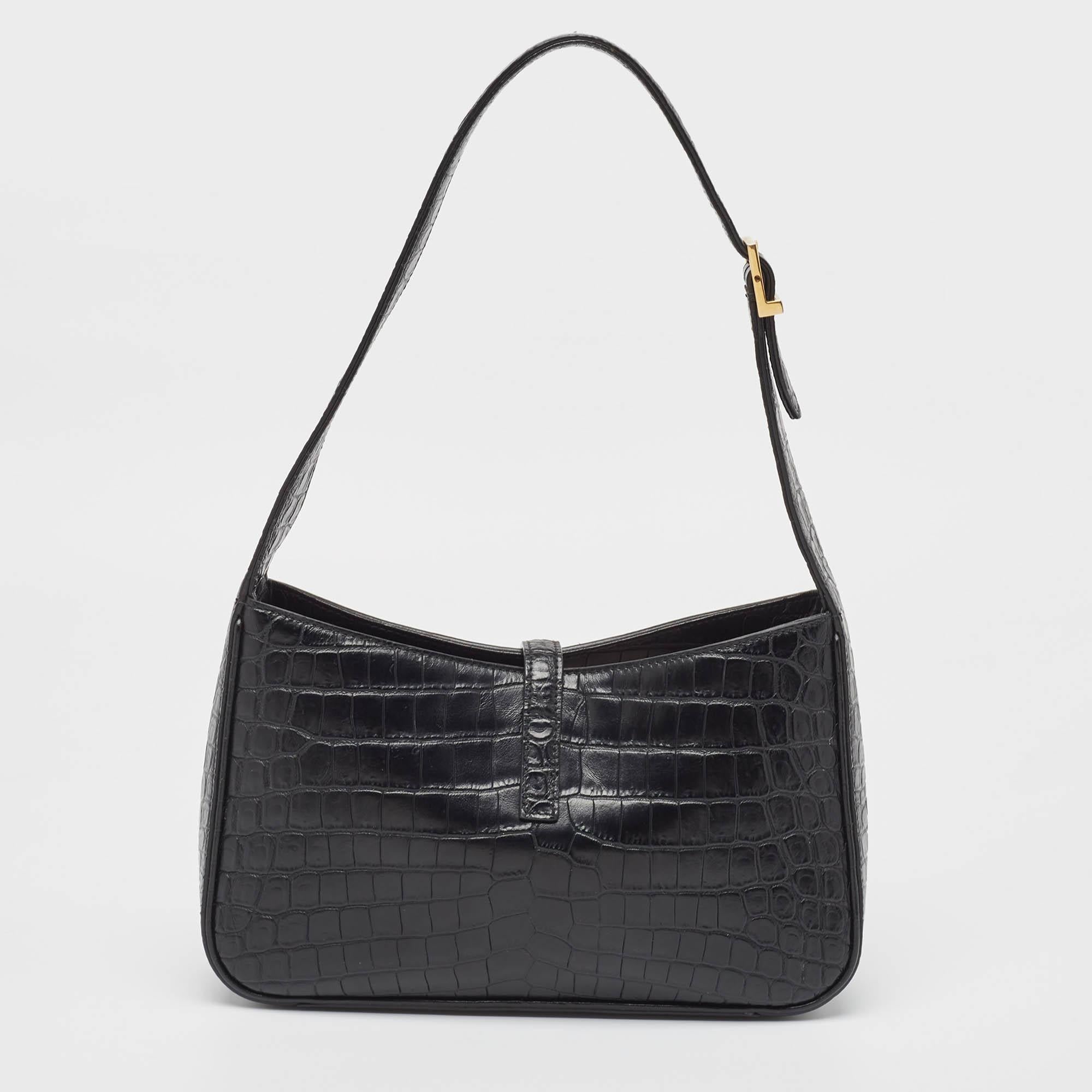 Classic in design and easy to hold, this hobo from Saint Laurent is worth investing in. The hobo is crafted from croc-embossed leather and gold-tone hardware. The YSL-detailed strap opens to an Alcantara-lined interior that can easily carry all your
