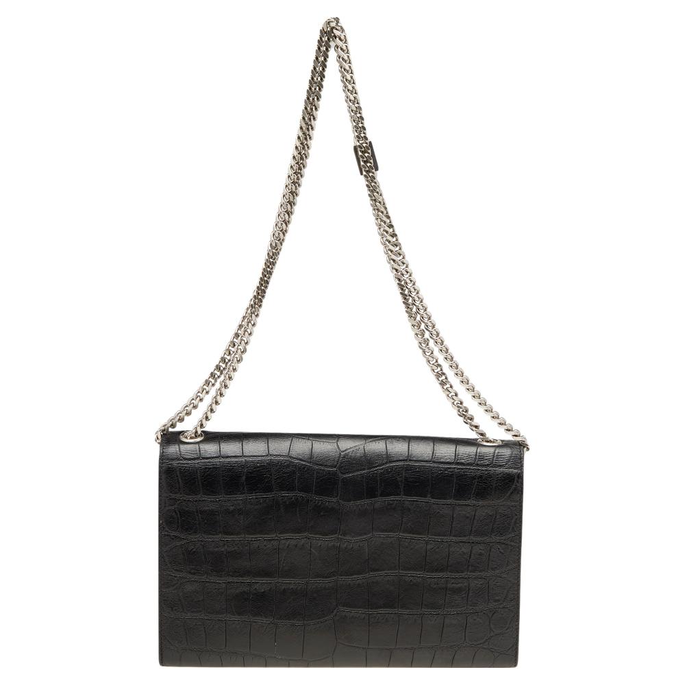 Meticulously crafted from croc-embossed leather, this Saint Laurent Kate bag exudes just the right amount of sophistication. The black bag features a sturdy silver-tone shoulder chain, the YSL logo with a tassel on the front flap, and a fabric-lined