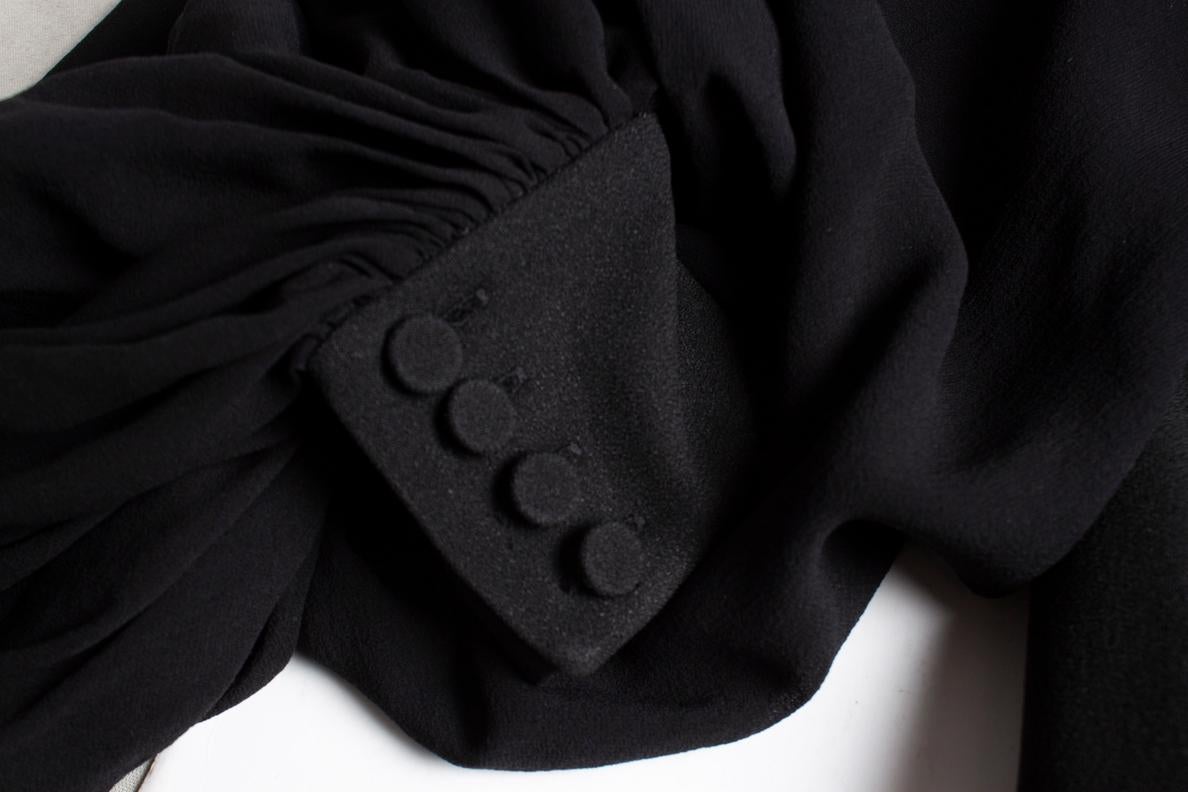 Saint Laurent, black dress with transparent puff sleeves and open cleavage. The item is in very good condition.

• CONDITION: very good condition 

• SIZE: FR38 - S 

• MEASUREMENTS: length 91 cm, width 47 cm, waist 50 cm, shoulder width 44 cm, arm