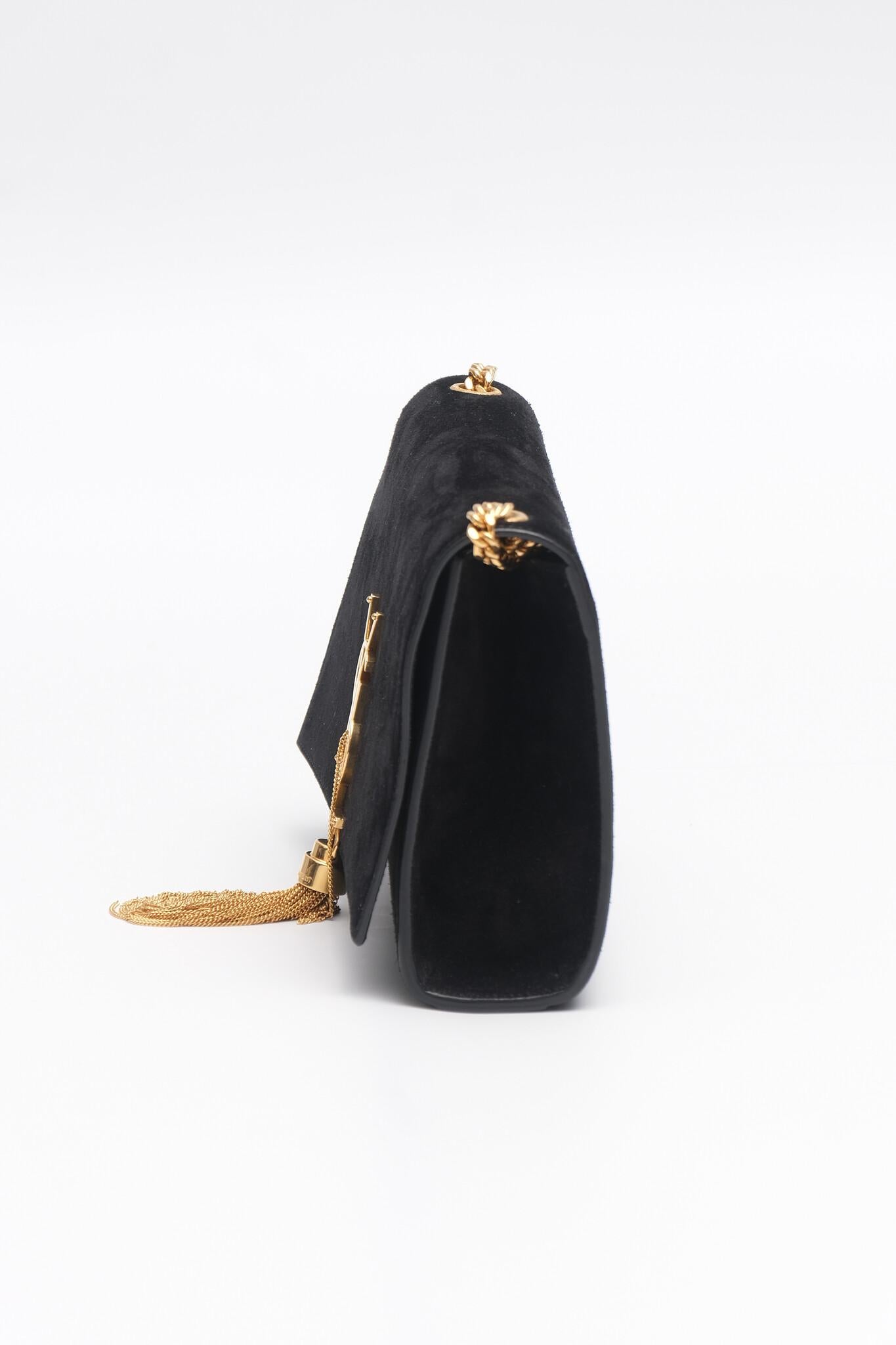 Saint Laurent Kate medium bag with gold-tone chain shoulder strap, perfectly complementing the iconic YSL monogram on the front flap. A delicate gold tassel adds a touch of sophistication, making it an ideal statement piece for evening wear. The
