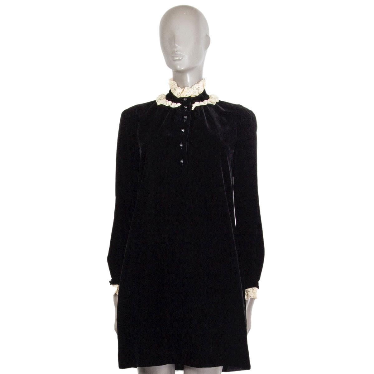 100% authentic Saint Laurent velvet dress in black and vanilla viscose (85%) cupro (35%) with a ruffled lace-collar, straight cut, two slit pockets on both sides, long sleeves with a ruffled lace finishing and buttoned cuff. Closes with button