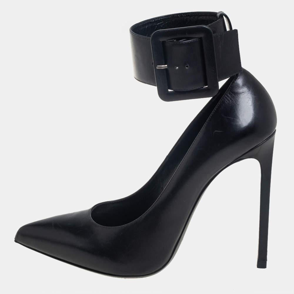 Simply stunning, these Saint Laurent Escarpin pumps will never fail to lift you up gracefully! They have been crafted from black leather and feature a pointed-toe silhouette. They flaunt wide ankle cuffs with buckles and come endowed with