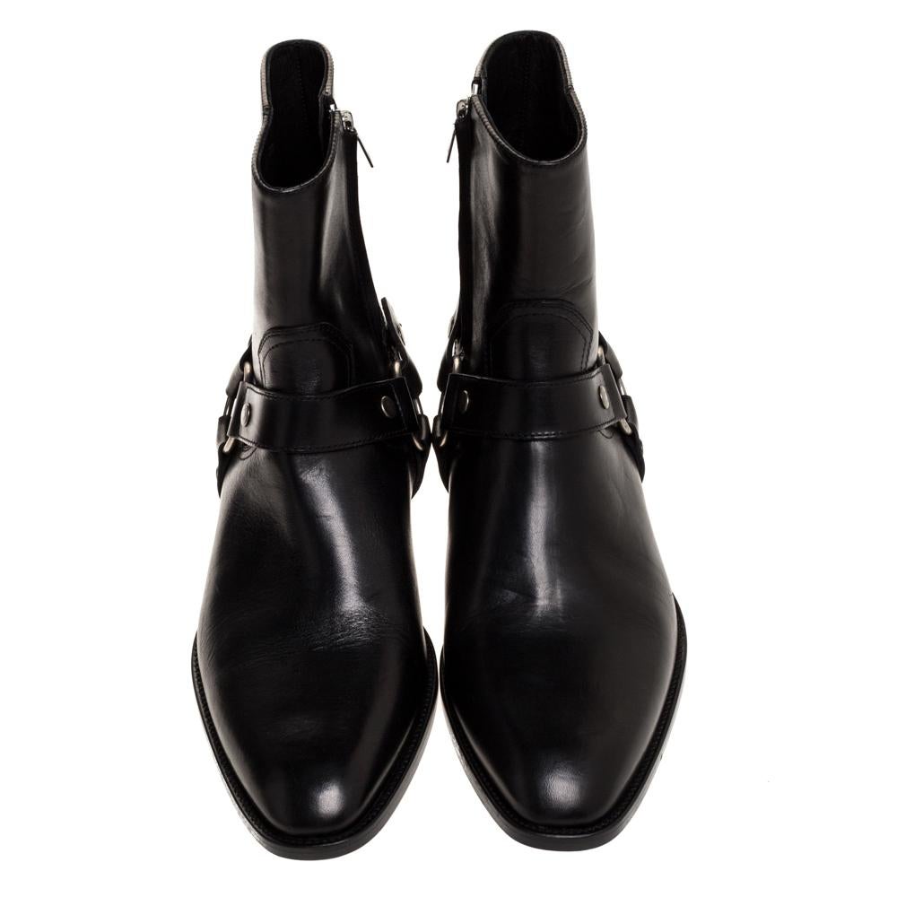 These fashionable Saint Lauren ankle boots made from black leather come with a sleek style and durable soles. They feature harness straps, 4 cm heels and impeccably-shaped toes. They are made to ensure a comfortable fit.

Includes: Original Dustbag,
