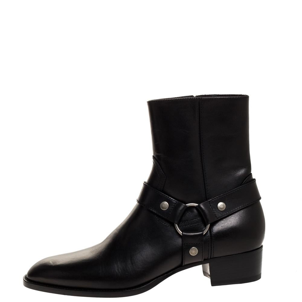 These fashionable Saint Lauren ankle boots made from black leather come with a sleek style and durable soles. They feature harness straps, 4 cm heels and impeccably-shaped toes. They are made to ensure a comfortable fit.

Includes: Original Dustbag,