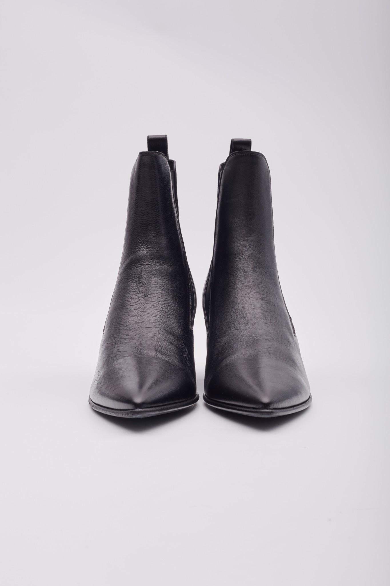Black heeled Chelsea boots from Saint Laurent. Made of calf leather, this pair features decorative elastic side panels, pointed toe and black leather sole. Retail.

Color: Black
Material: Calf Leather
Model No. 685837
Size: EU 44 / US 11 Mens
Heel