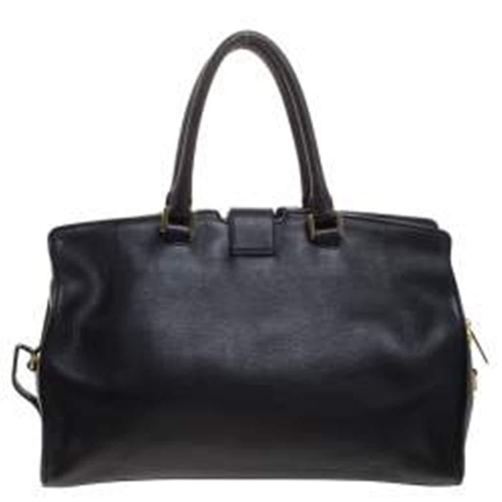 This elegant black Cabas Chyc tote from Saint Laurent is ideal for everyday use. Crafted from leather, the bag is detailed with a gold-tone Y motif snap closure and dual-rolled handles. The top zip closure opens to a spacious interior that is