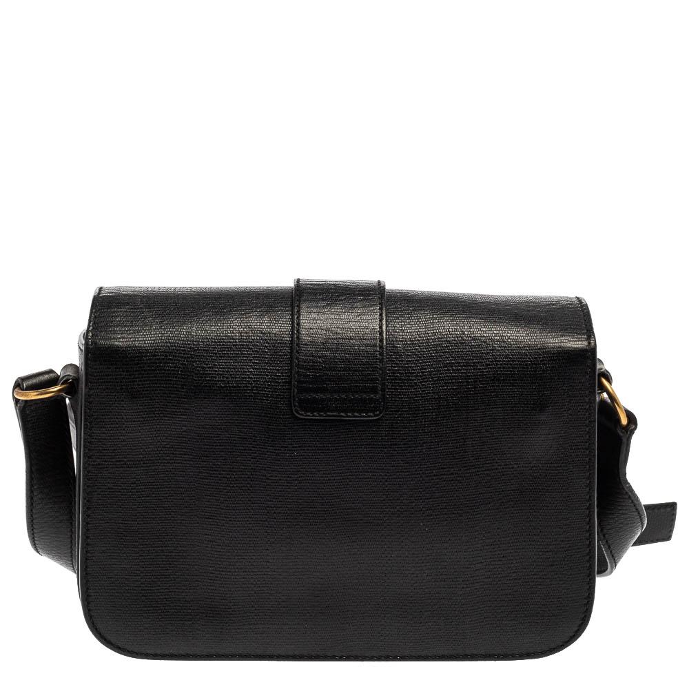This black Chyc bag from Saint Laurent is ideal for everyday use. Crafted from leather, the bag is detailed with a gold-tone hardware 'Y' motif snap closure and an adjustable shoulder strap. It opens to a spacious satin interior that is perfectly