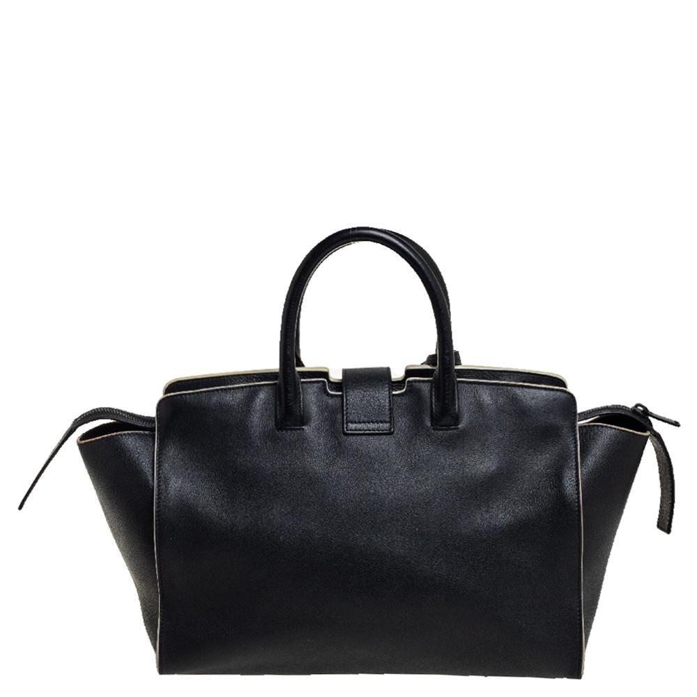 This classy Downtown Cabas tote coming from Saint Laurent will adorn your look in the most stylish ways. It is crafted from leather in a black hue featuring two rolled handles. This tote comes with a spacious interior along with brand labeling. It