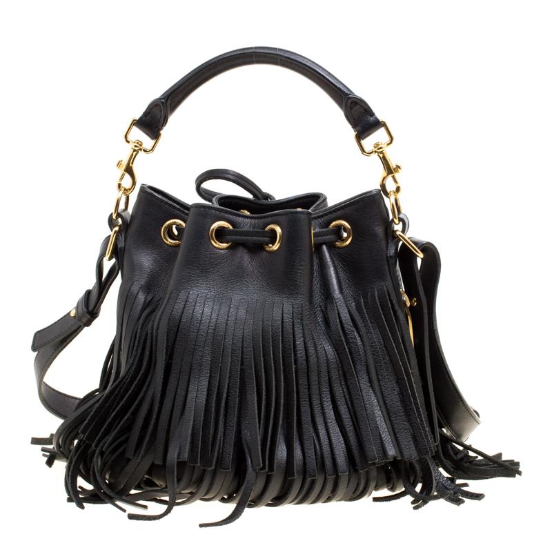 Carry your daily essentials in a smart and trendy way by adding this chic bucket bag from Yves Saint Laurent to your wardrobe! The black bag is crafted from leather and features a fringed design with a drawstring closure that opens to reveal a suede