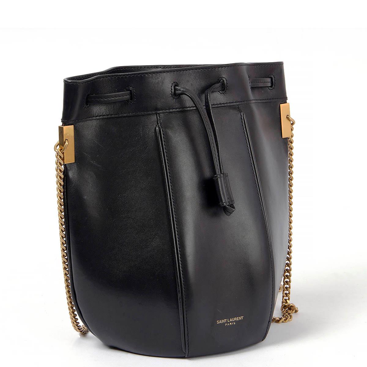 100% authentic Saint Laurent Talitha bucket bag in smooth black leather featuring antique gold-tone chain shoulder-strap. Lined in black grosgrain with one open pocket against the back. Has been carried and shows some scratches especially on the