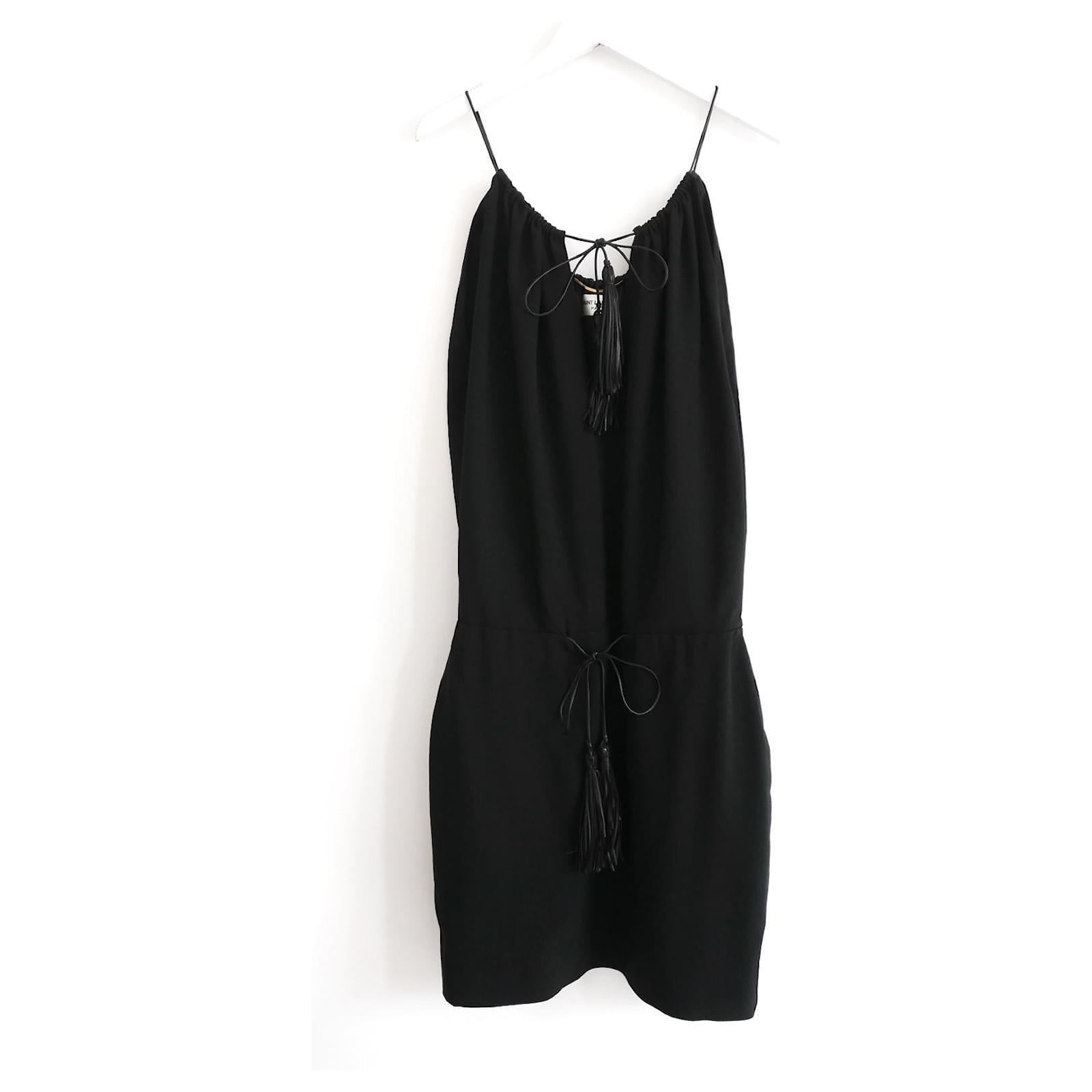 Signature 70s inspired party dress from Saint Laurent. Bought for €2850 and new with tag. Made from black acetate mix crepe with leather tassel ties to neck and waist. Has a loose fit bodice and fitted skirt. lined in silk. Size FR34/UK6 and will
