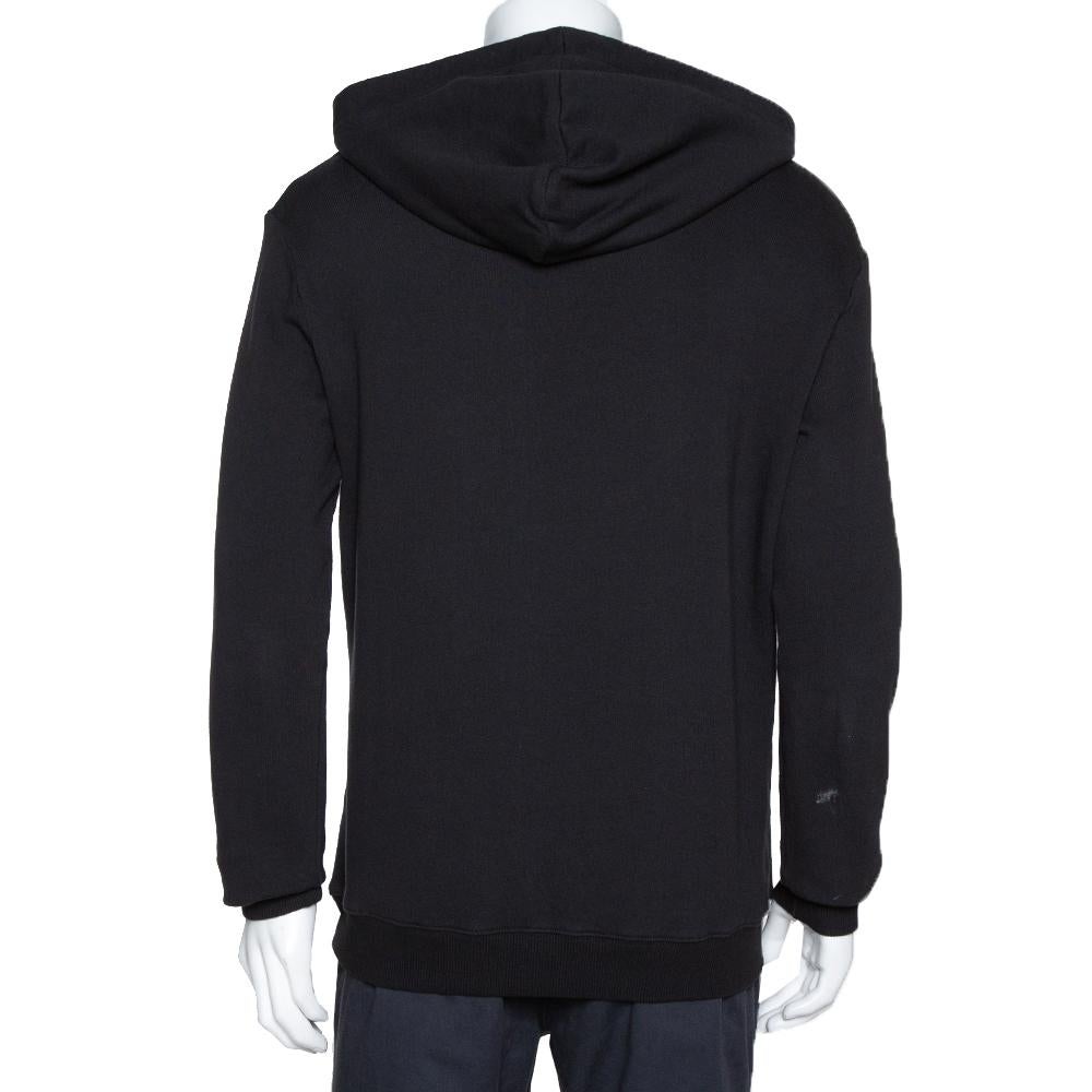 This black sweatshirt from Saint Laurent comes with logo detail to light up your casual style. It is made from cotton and designed as a hoodie featuring long sleeves. The comfortable creation will pair well with a variety of bottoms.


