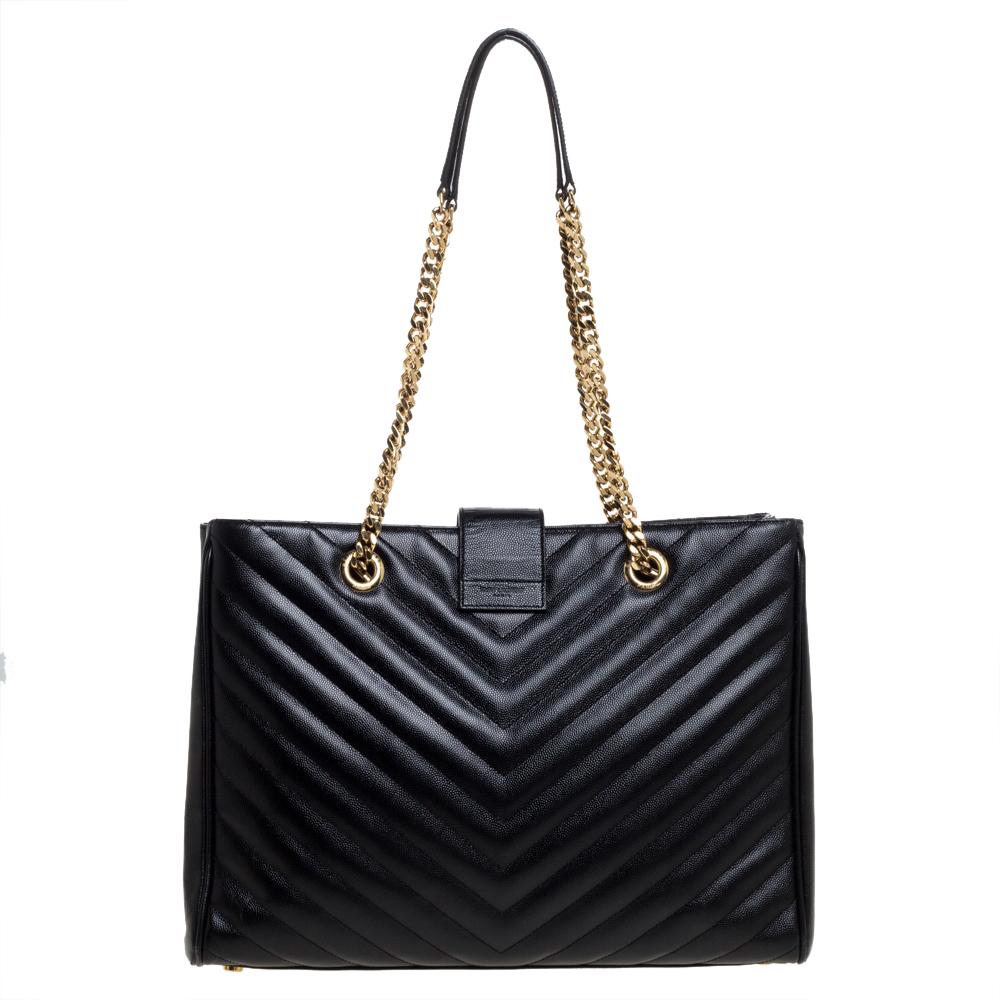 This exquisite Cassandre shopper tote from Saint Laurent is a chic accessory that represents the brand's rich aesthetics and elegant designs. Crafted from black leather, this easy-to-carry bag has a flap style with the YSL logo in gold-tone on the