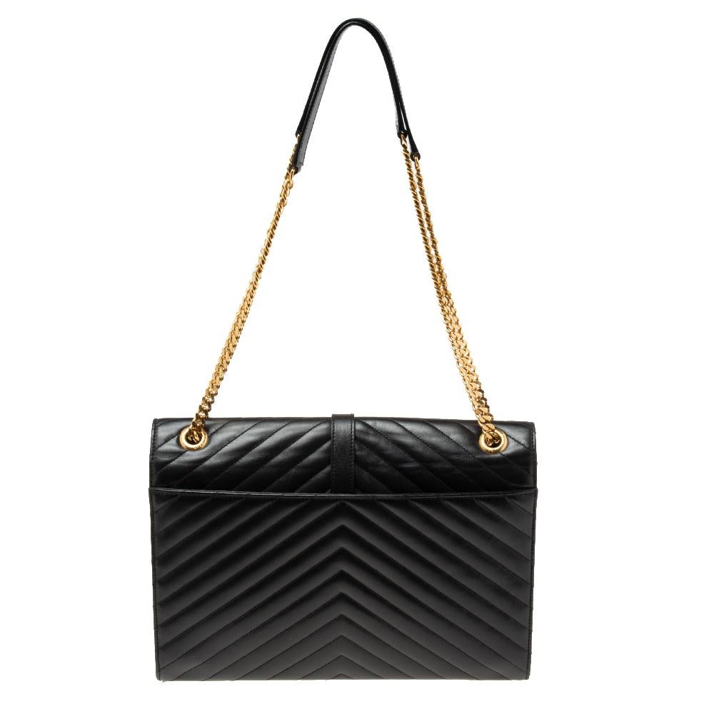 Fashioned using Matelassé leather into a structured silhouette, this black Saint Laurent shoulder bag has high style and a timeless charm. It has a flap design and the front is highlighted with a gold-tone YSL logo. The interior is lined with