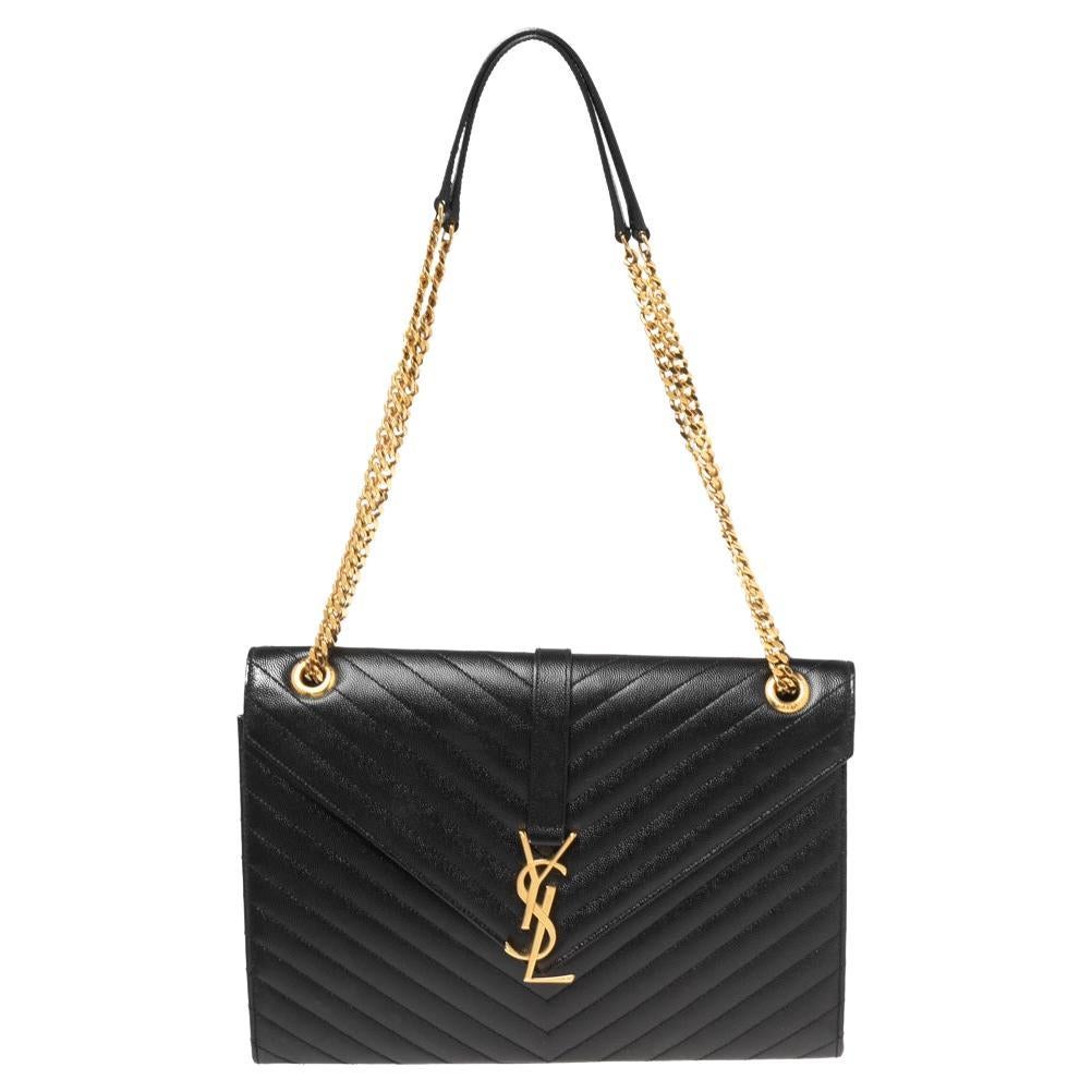 Fashioned using Matelassé leather into a structured silhouette, this black Saint Laurent shoulder bag has high style and a timeless charm. It has a flap design and the front is highlighted with a gold-tone YSL logo. The interior is lined with