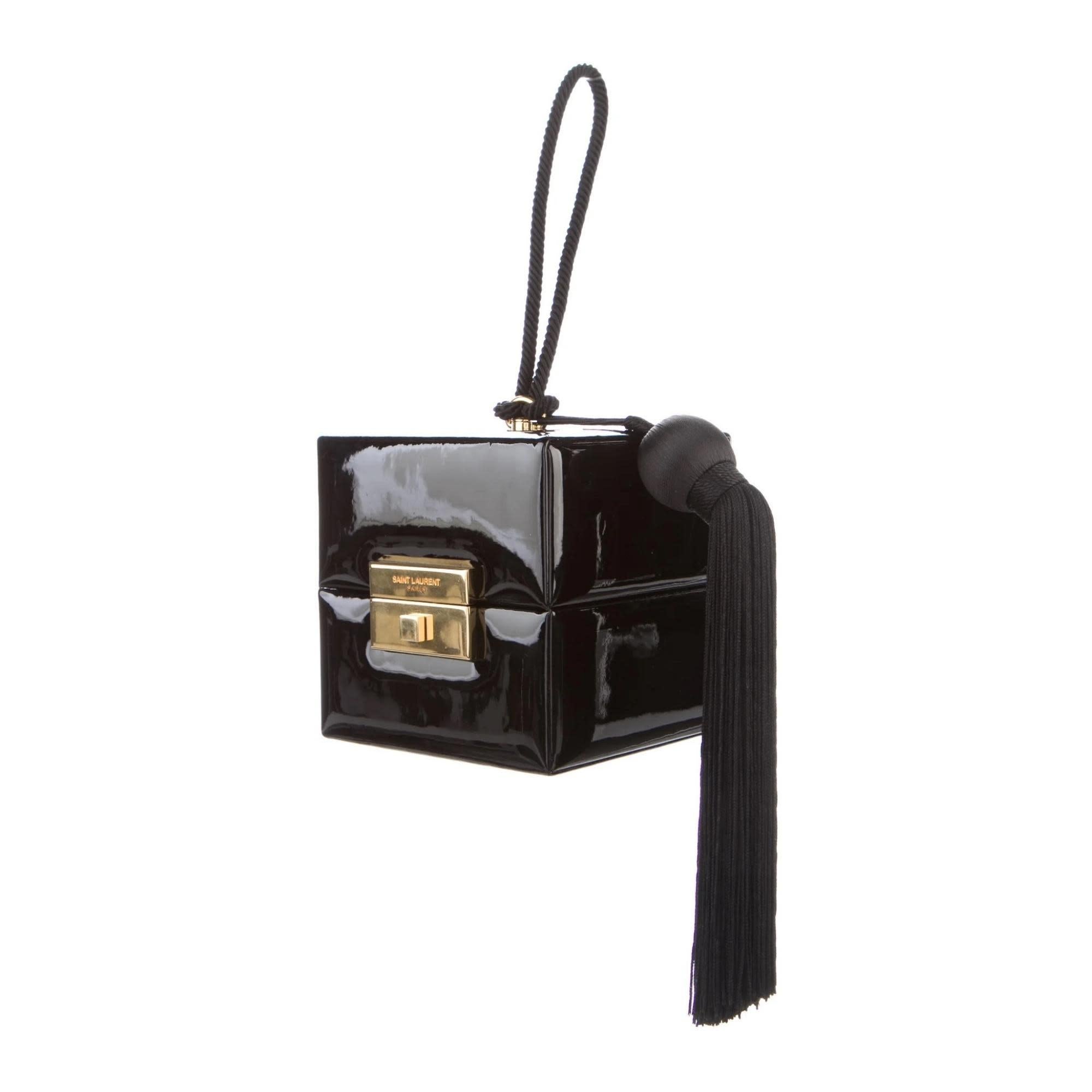 SAINT LAURENT BLACK PATENT CUBE BAG WRISTLET

Color: Black
Material: Patent leather
Model No. 538454
Comes with:Dust bag and care card
Condition: Like new. Pristine with light hardware scratches.
Made in Italy

Measurements~
Height 6”
Length 6