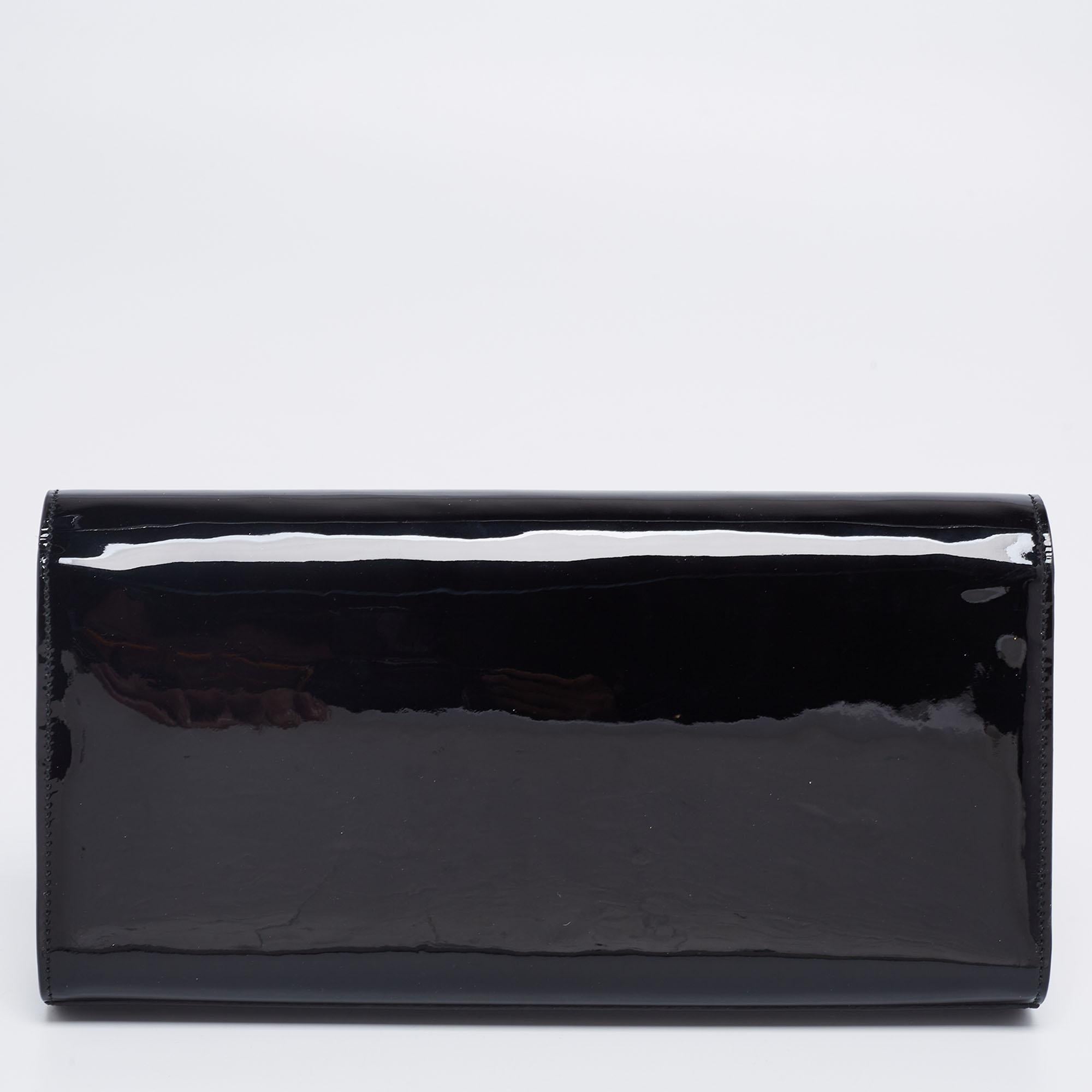 Meticulously crafted from glossy patent leather, this black Saint Laurent Kate clutch delivers a sophisticated look. The clutch features a gold-tone YSL logo on the front flap and a suede interior with a slip pocket.

Includes: Info Booklet