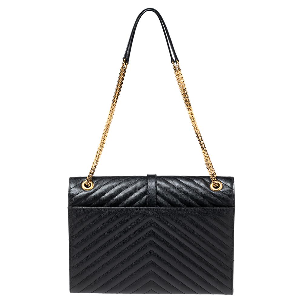 Fashioned using chevron-quilted leather into a structured silhouette, this Saint Laurent shoulder bag has high style and a timeless charm. It has a flap design and the front is highlighted with a gold-tone YSL logo. The interior is lined with fabric.