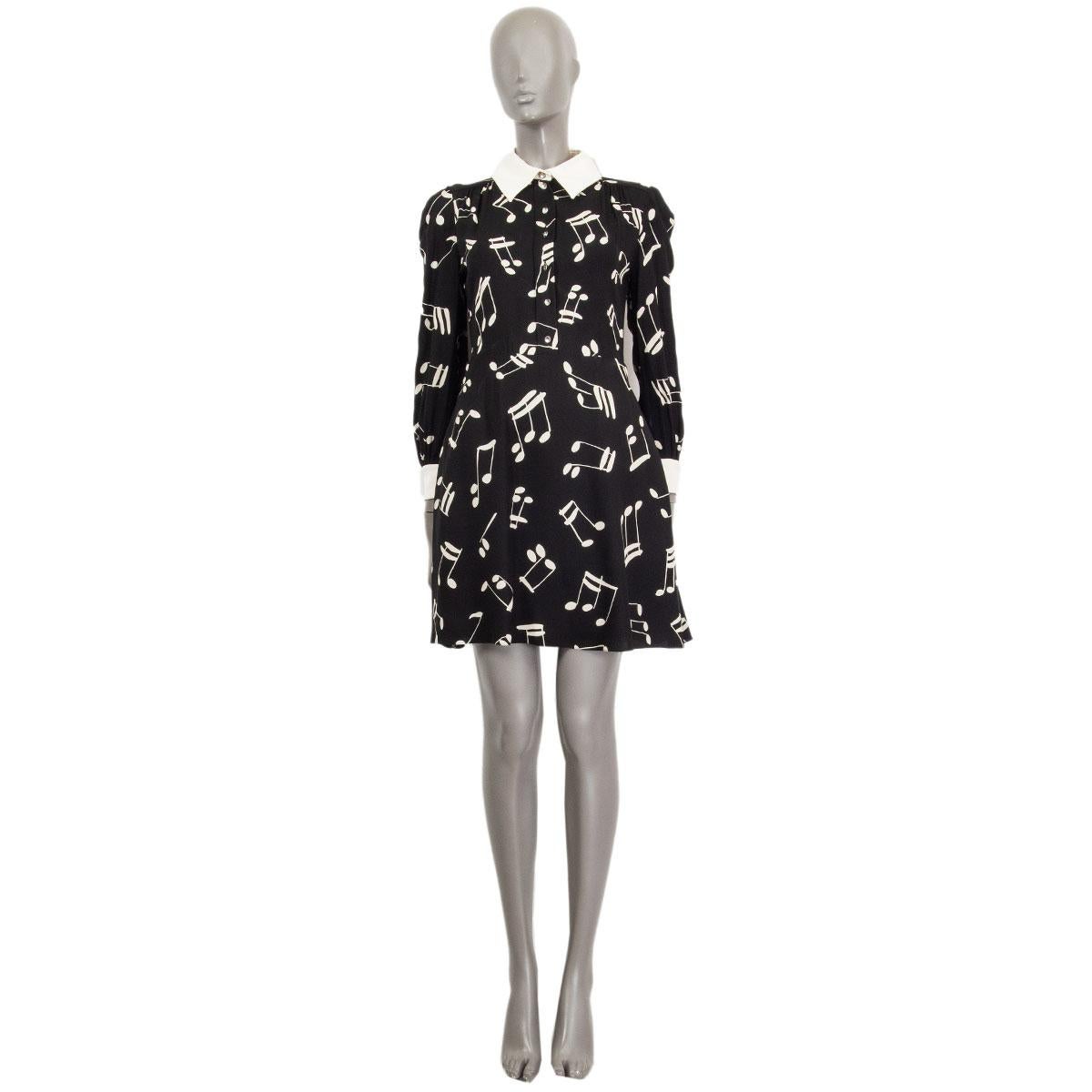 100% authentic Saint Laurent music note printed shirt dress in black, off-white and cream viscose (100%) and silk (100%). Features crystal buttons on front and cuffs. Has two slit pockets on the side and opens with a side zipper. Has been worn and