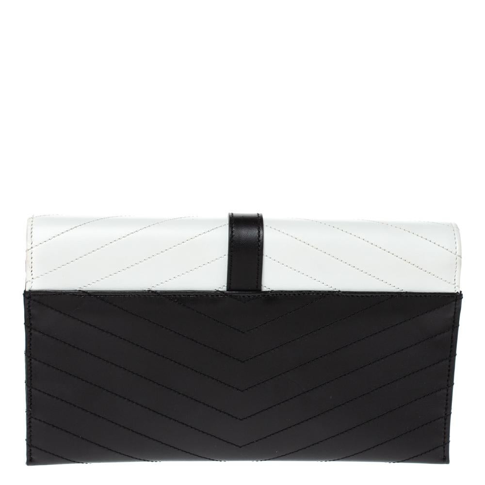 An elegant creation to add to your collection, this Saint Laurent envelope clutch is a special one. Crafted in black and white matelasse leather, this clutch has a gold-tone YSL logo detail at the front for a signature finish.

Includes: Original