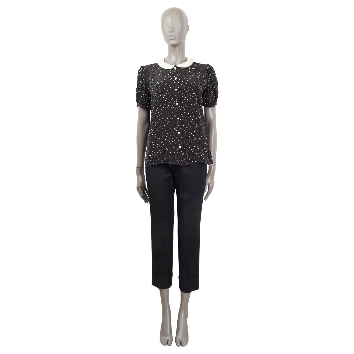 100% authentic Saint Laurent short sleeve polka dot shirt in black and white silk (100%). Features a white peter pan collar and opens with seven white rose buttons on the front. Unlined. Has been worn and is in excellent condition.

Measurements
Tag