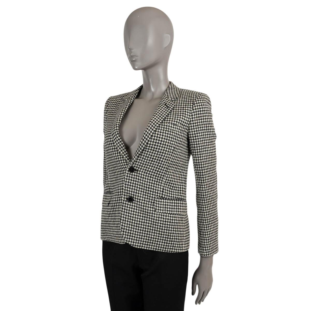 100% authentic Saint Laurent houndstooth blazer in black and white wool (100%). Features two flap and chest pockets, buttoned sleeves and black elbow patches. Closes with two buttons and is lined in silk (100%). Has been worn and is in excellent