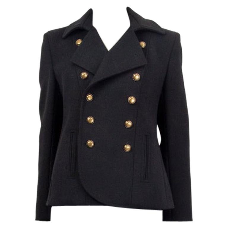 Saint Laurent double breasted jacket in black wool (100%) with six antique gold-tone buttons on each side. Lined in black silk (100%). Two slit pockets at front. Has been worn and is in excellent condition.

Tag Size 38
Size S
Shoulder Width 41cm